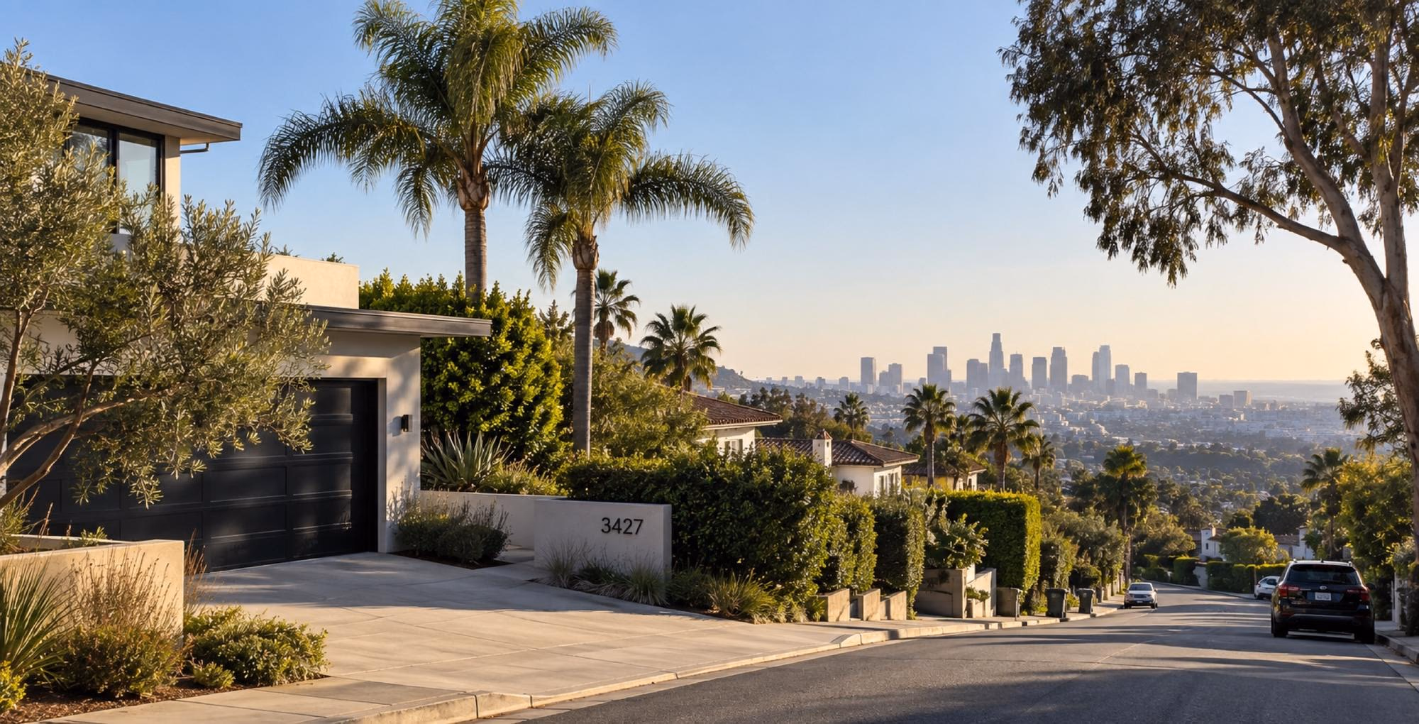 Palm-lined residential street with the Los Angeles skyline behind